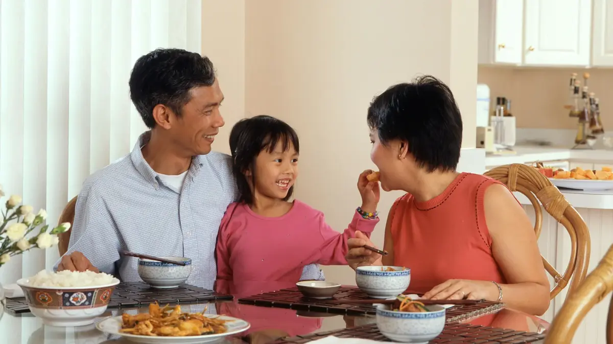 Adoptive family relaxing together on the couch at home