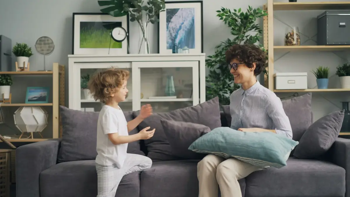 Parent kneeling down to comfort a young child at eye level