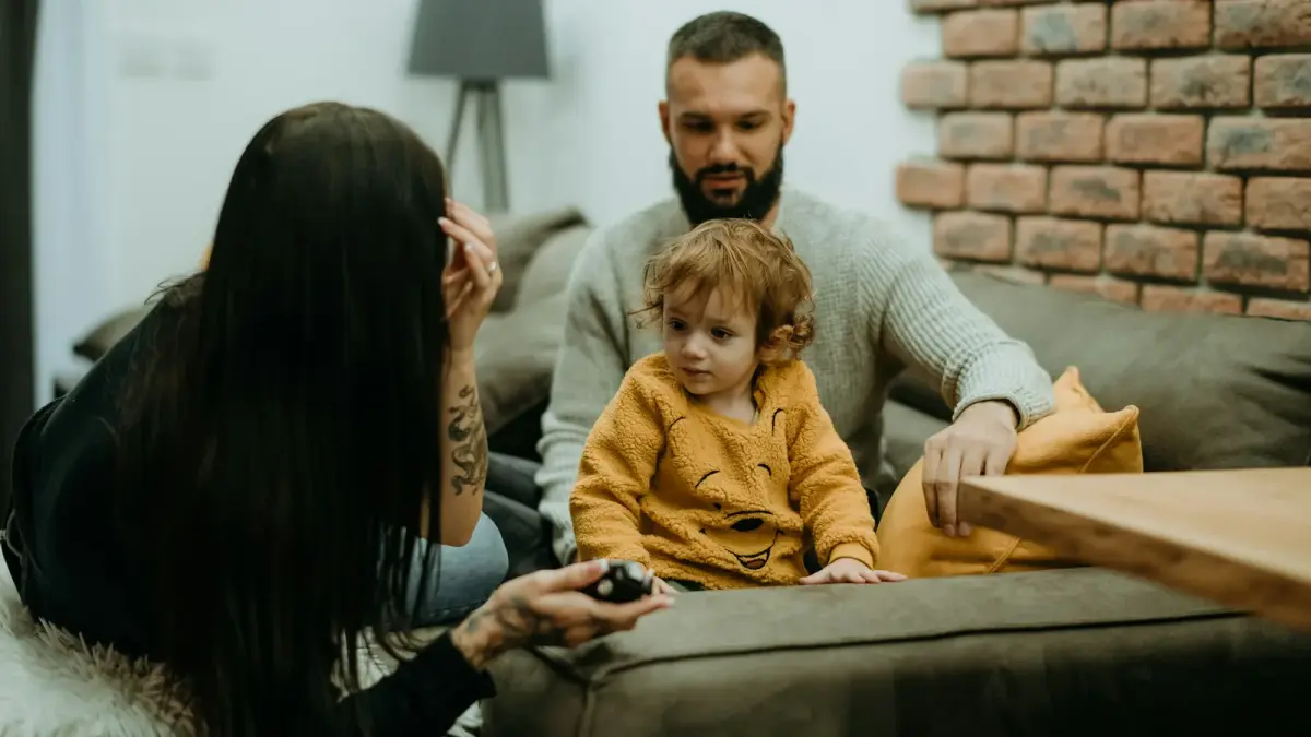 Parent speaking calmly at eye level with a child during a difficult moment