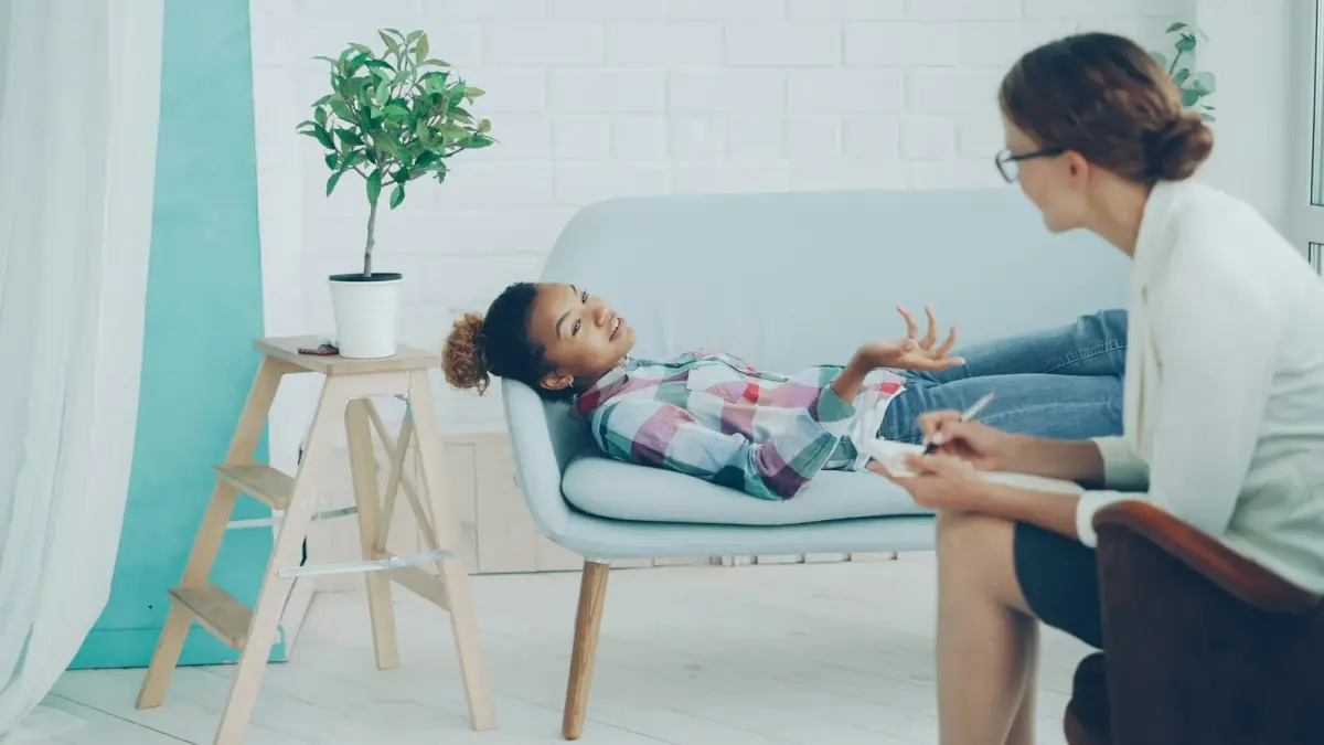 Child and therapist talking together during a counseling session
