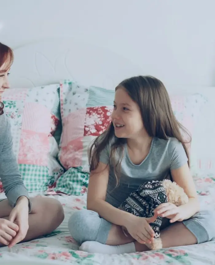 A parent and child sharing a warm conversation at home